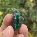 Behold the exquisite beauty of Emerald on Black Rock, a captivating fusion of vibrant green and deep, dramatic contrast. These emerald crystals emerge from a striking black rock matrix, creating a stunning visual symphony.
